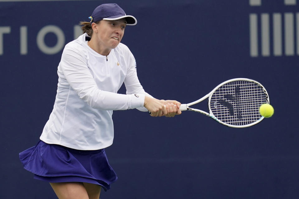 Iga Swiatek of Poland returns to Qinwen Zheng of China at the San Diego Open tennis tournament Thursday, Oct. 13, 2022, in San Diego. (AP Photo/Gregory Bull)