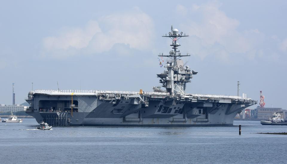 The nuclear-powered aircraft carrier USS George Washington leaves the US naval base in Yokosuka, 60 kms south of Tokyo, for the last time for refueling and complex overhaul on May 18, 2015.  / Credit: TORU YAMANAKA/AFP via Getty Images