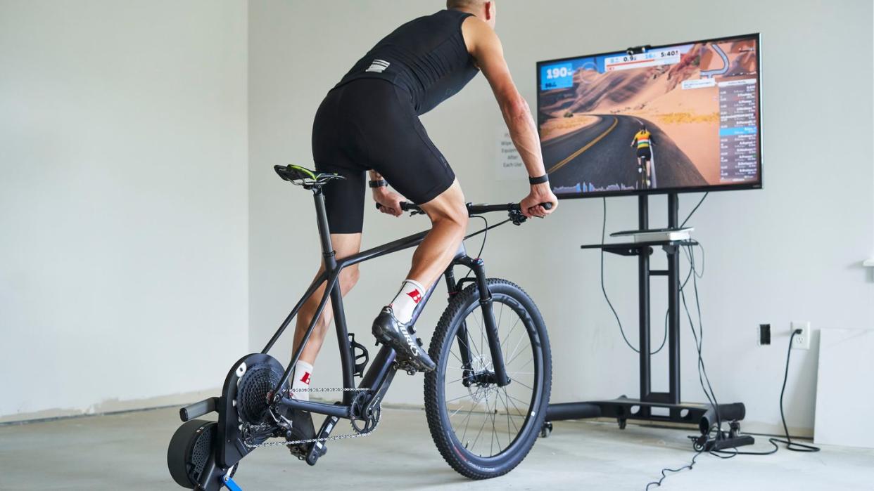 a person riding a mountain bike on an indoor trainer