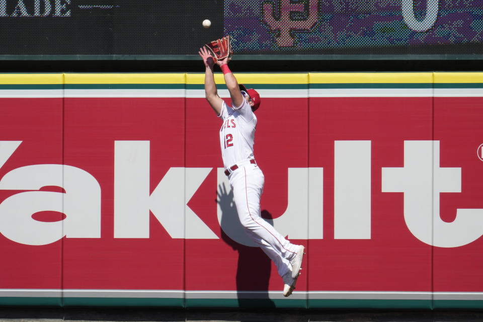 Los Angeles Angels right fielder Hunter Renfroe makes a leaping catch at the wall on a fly ball from Toronto Blue Jays' Daulton Varsho during the seventh inning of a baseball game, Sunday, April 9, 2023, in Anaheim, Calif. (AP Photo/Marcio Jose Sanchez)