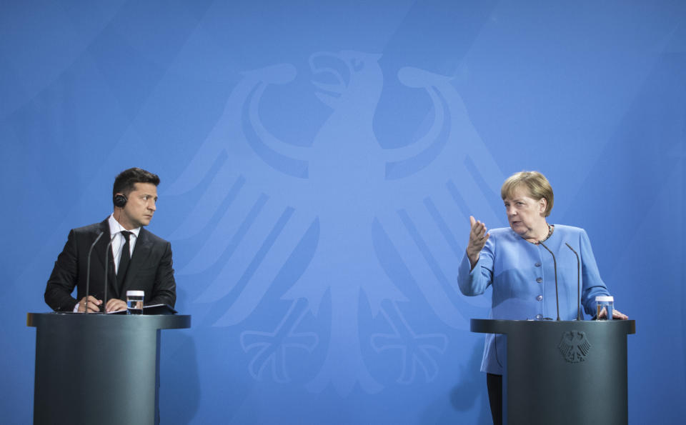 German Chancellor Angela Merkel, right, and Ukrainian President Volodymyr Zelensky give statements ahead of talks at the Chancellery in Berlin, Monday, July 12, 2021. (Stefanie Loos/Pool Photo via AP)