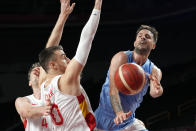 Argentina's Nicolas Laprovittola passes around Spain's Victor Claver, left, during a men's basketball preliminary round game at the 2020 Summer Olympics, Thursday, July 29, 2021, in Saitama, Japan. (AP Photo/Eric Gay)