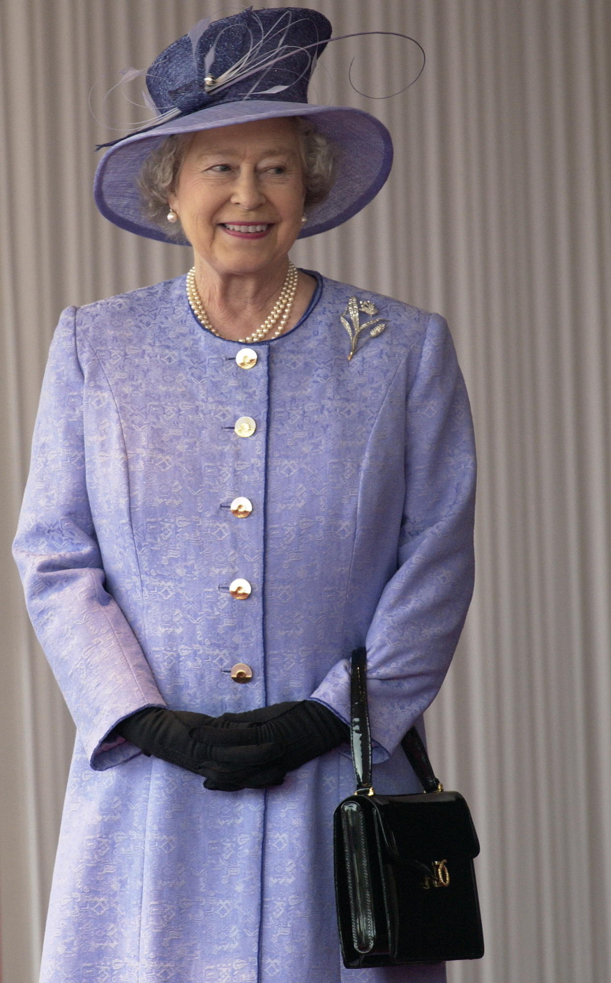 LONDON, UNITED KINGDOM - NOVEMBER 19:  Queen Elizabeth Ll Smiling During The State Visit Of The American President At Buckingham Palace.  The Queen Is Wearing A Mauve Coat With Matching Hat Which She Has Accessorized With Black Gloves And A Black Launer Handbag.  (Photo by Tim Graham Photo Library via Getty Images)