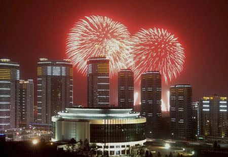 Fireworks explode in the sky over high rise buildings in Pyongyang in this undated photo released January 1, 2015. REUTERS/KCNA