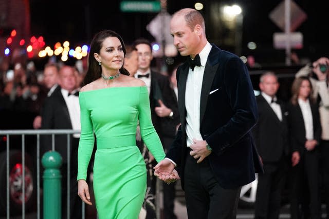 The Prince and Princess of Wales walk the green carpet