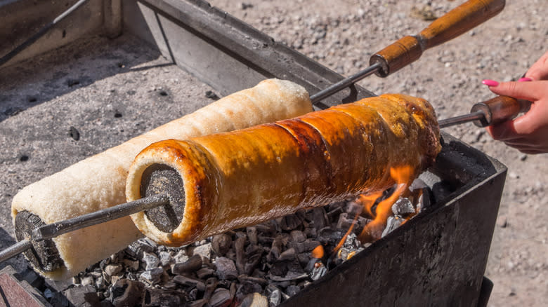 Person making traditional chimney cake