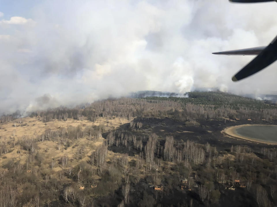 In this photo made on Saturday, April 4, 2020, an aerial view of a forest fire burning near the village of Volodymyrivka in the exclusion zone around the Chernobyl nuclear power plant, Ukraine. The fire was still burning on Sunday, April 5, Emergency Ministry firemen kept extinguishing the fire. (Emergency Situation Ministry via AP)