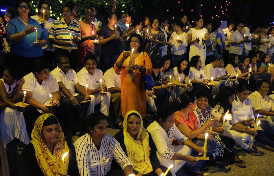 Pro- democratic Sri Lankans take part in a candle light vigil, in Colombo, Sri Lanka, Sunday, Nov. 11, 2018. The crowd demanded the restoration of democracy after President Maithripala Sirisena dissolved Parliament and called for fresh elections. (AP Photo/Eranga Jayawardena)