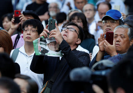 People use smartphones to take photos of the head of Japan's Party of Hope and Tokyo Governor Yuriko Koike during her election campaign rally in Tokyo, Japan, October 10, 2017. REUTERS/Issei Kato
