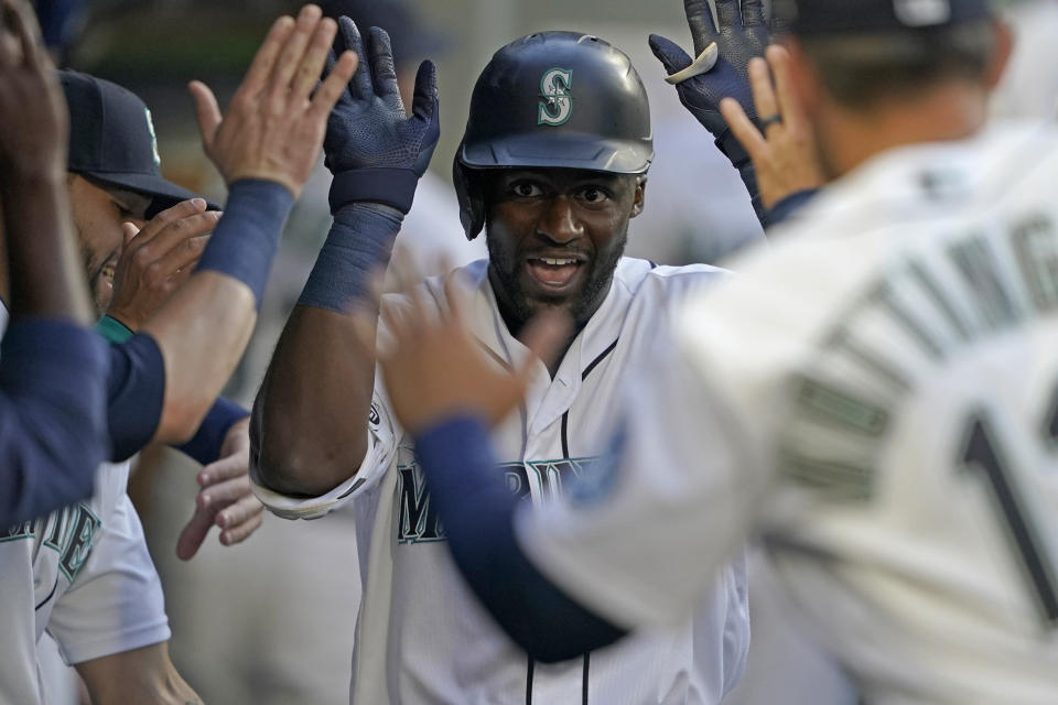 Seattle Mariners' Taylor Trammell is greeted in the dugout after he hit a solo home run against the Oakland Athletics during the fourth inning of a baseball game Tuesday, June 1, 2021, in Seattle. (AP Photo/Ted S. Warren)