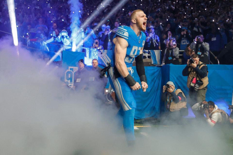 Detroit Lions defensive end Aidan Hutchinson runs out of the tunnel for player introductions before kickoff against the Tampa Bay Buccaneers in the NFC divisional round at Ford Field in Detroit on Sunday, Jan. 21, 2024.