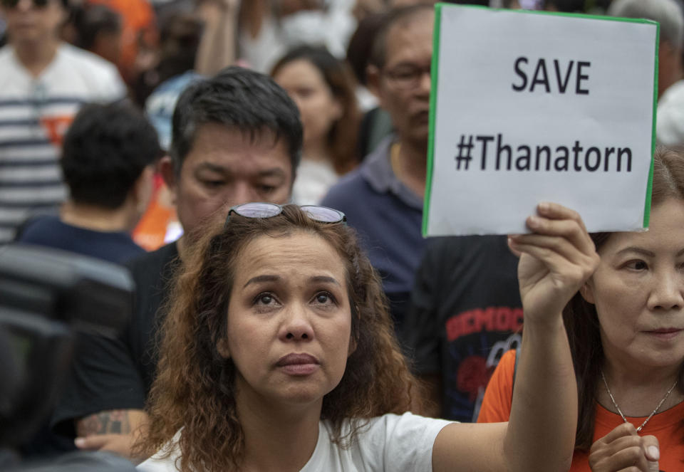 A supporter of Thanathorn Juangroongruangkit, leader of the anti-military Future Forward Party displays a placard at Constitutional Court in Bangkok, Thailand, Wednesday, Nov. 20, 2019. Thailand's Constitutional Court ruled Wednesday that Thanathorn violated election laws and cannot keep his seat in Parliament. (AP Photo/Gemunu Amarasinghe)