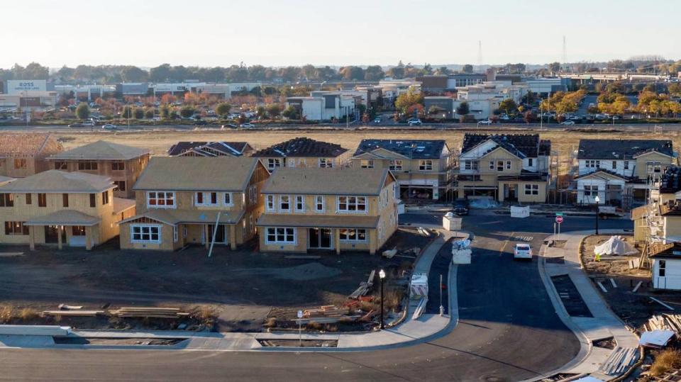 New homes rise in the Delta Shores development near the shopping center in south Sacramento on Dec. 12, 2023.