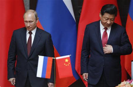 Russia's President Vladimir Putin (L) and China's President Xi Jinping attend an agreement signing ceremony during a bilateral meeting at Xijiao State Guesthouse ahead of the fourth Conference on Interaction and Confidence Building Measures in Asia (CICA) summit, in Shanghai May 20, 2014. REUTERS/Carlos Barria