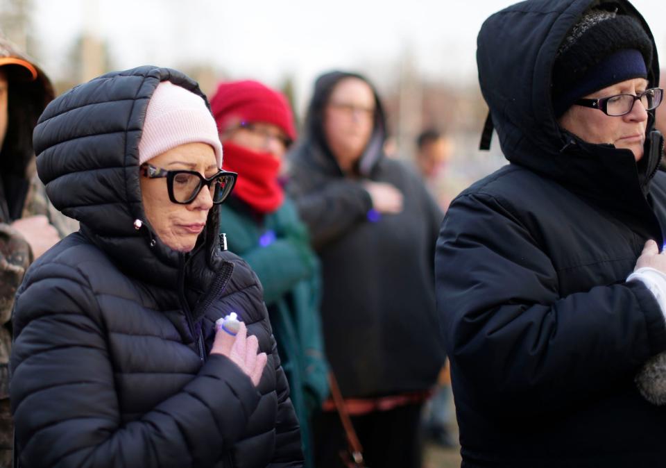 People close their eyes during a vigil held for 3-year-old Elijah Vue on Saturday, March 16, 2024, in Two Rivers, Wisconsin.