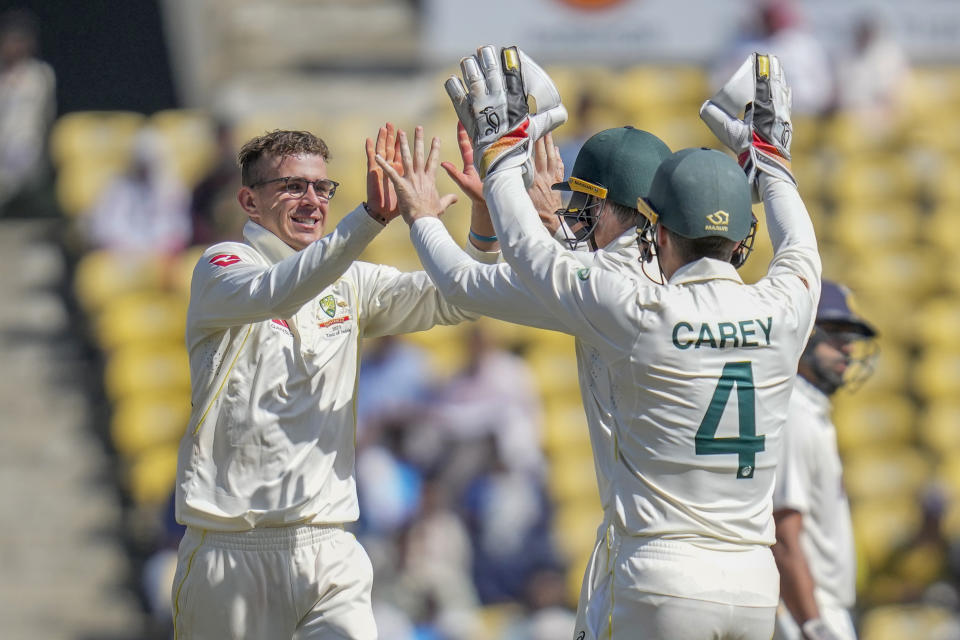 Australia's Todd Murphy, left, celebrates with teammates dismissal of India's Cheteshwar Pujara along with his teammates during the second day of the first cricket test match between India and Australia in Nagpur, India, Friday, Feb. 10, 2023. (AP Photo/Rafiq Maqbool)