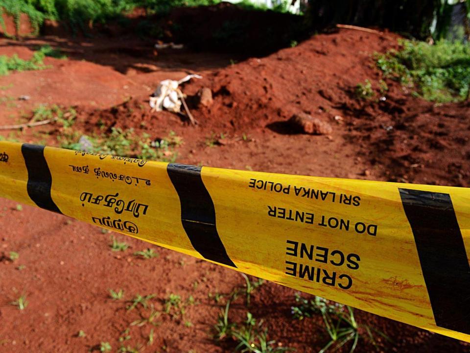 Police tape closes off part of a mass grave where authorities found skeletal remains of over 150 people at the Matale hospital compound in central Sri Lanka (AFP/Getty)