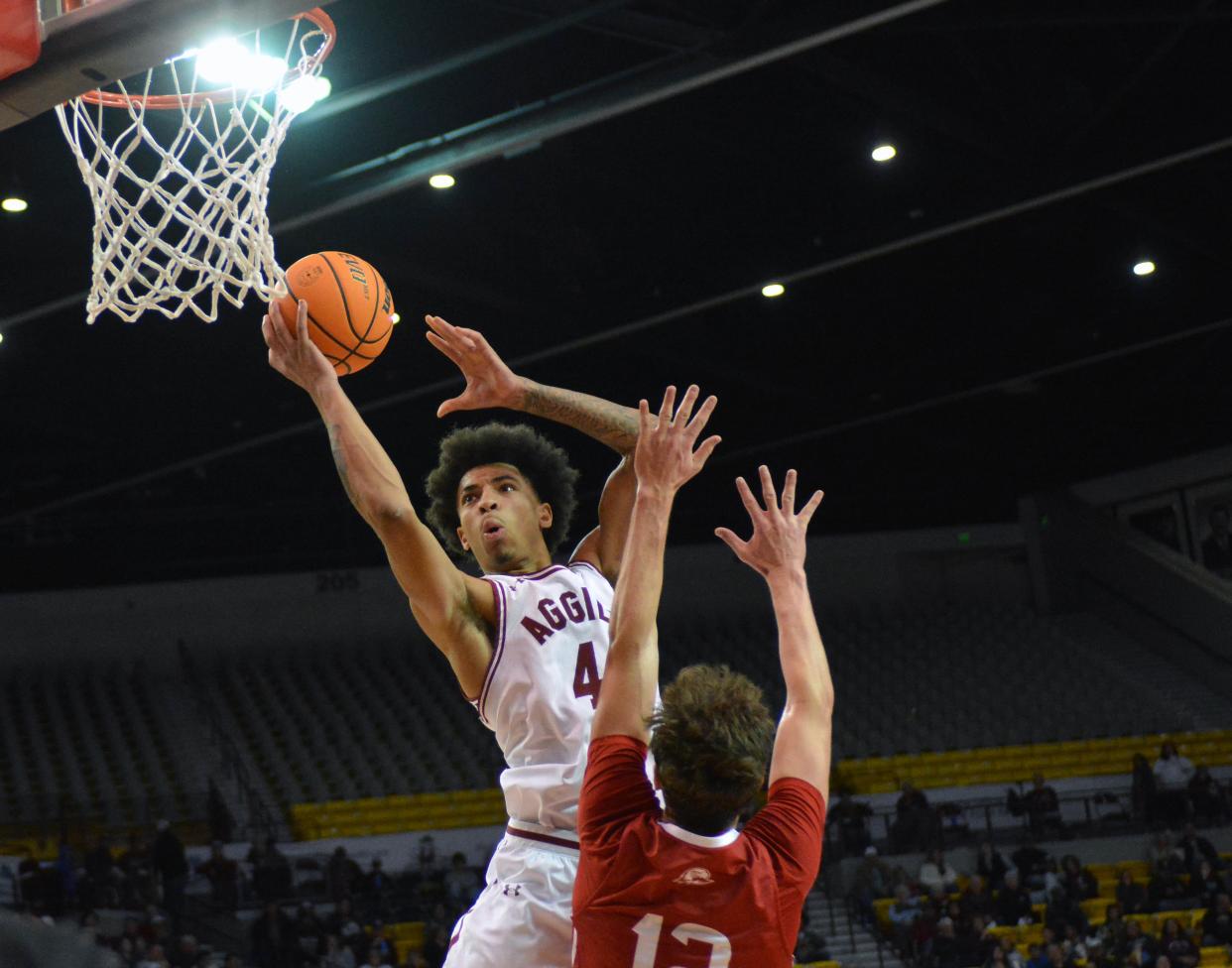 New Mexico State guard Deshawndre Washington goes up for an easy shot as NMSU took on Southern Utah University on Wednesday night at the Pan Am.