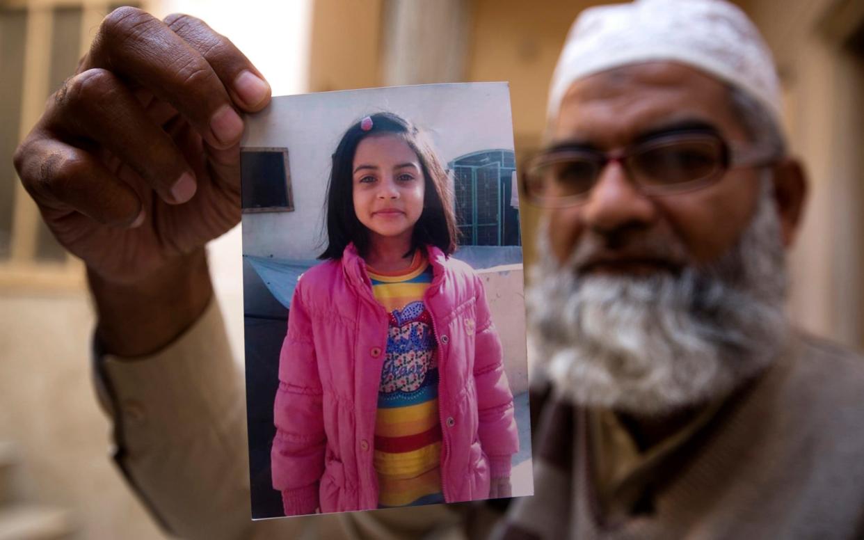 Mohammed Amin, the father of murder victim Zainab Ansari, shows a picture of his daughter - AP