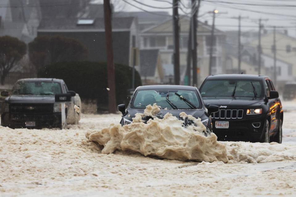 PHOTO: A car drove through a flooded street during a nor'easter in Salisbury, Mass. on April 4, 2024. (Jessica Rinaldi/The Boston Globe via Getty Images, FILE)