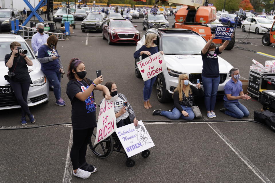 People listen during a campaign stop for Democratic presidential candidate former Vice President Joe Biden at Bucks County Community College, Saturday, Oct. 24, 2020, in Bristol, Pa. (AP Photo/Andrew Harnik)