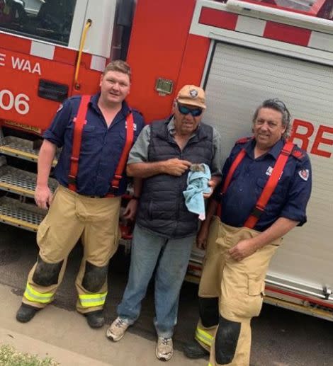 The cat was later adopted by local man Clancy Hamilton, who posed for photos with the firefighters involved in the rescue with his new kitten. Source: Fire and Rescue NSW