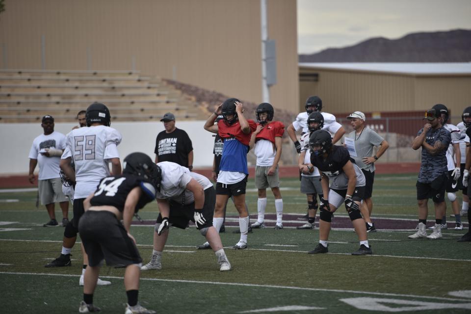 Tyler Brown (red pennie, blue undershirt) and Abe Rosenlund (red pennie, white undershirt) have battled all camp to become the new starting quarterback for Pine View.