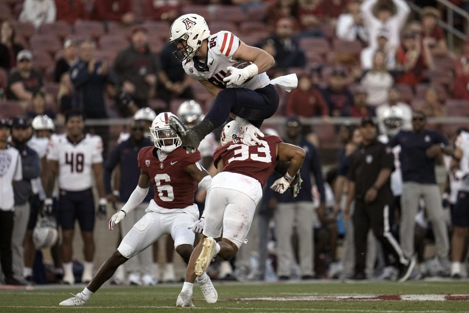 Arizona tight end Tanner McLachlan (84) hurdles Stanford safety Alaka'i Gilman (33) during the second half of an NCAA college football game Saturday, Sept. 23, 2023, in Stanford, Calif. (AP Photo/Godofredo A. Vásquez)