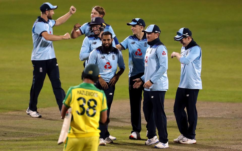 England's Jos Buttler (third left) and Adil Rashid (centre) celebrate with their team-mates after they combine to dismiss Australia's Alex Carey  - PA