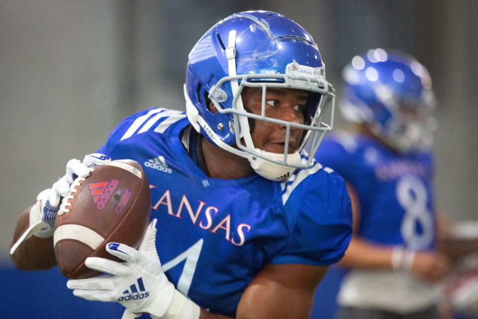 Kansas sophomore running back Devin Neal (4) makes a catch during a drill at a practice this fall at the indoor practice facility.