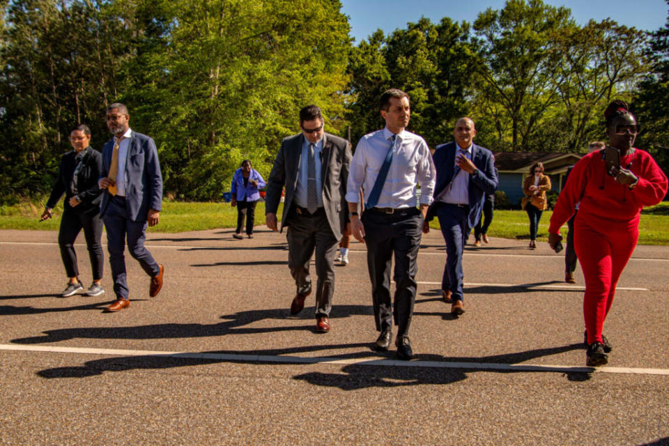 A group of people in suits in the middle of the road