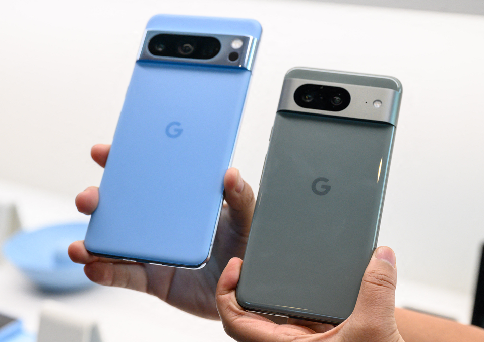 A person holds the new Google Pixel 8 and Pixel 8 Pro.