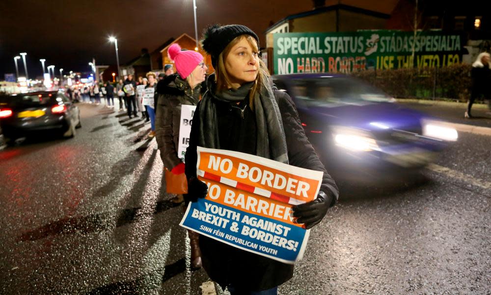 Protesters near an anti-Brexit mural erected by Sinn Féin in west Belfast, December 2017.