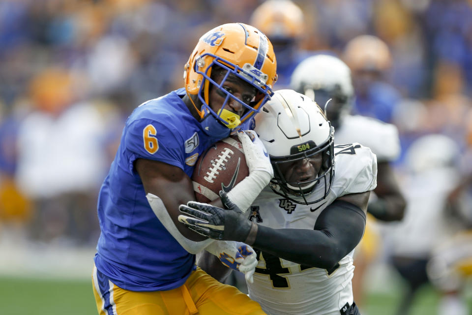 Pittsburgh wide receiver Aaron Mathews (6) tries to get away from Central Florida linebacker Nate Evans (44) after making a catch during the first half of an NCAA college football game, Saturday, Sept. 21, 2019, in Pittsburgh. (AP Photo/Keith Srakocic)