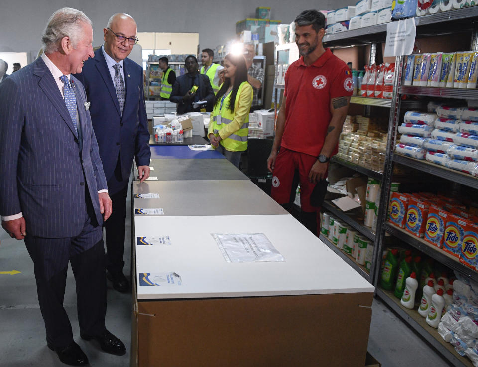 Britain's Prince Charles walks with Raed Arafat, right, the head of Romania's Department for Emergency Situations (DSU) during a visit at a center for refugees fleeing the war in neighboring Ukraine, at the Romexpo convention center, in Bucharest, Romania, Wednesday, May 25, 2022. (Alex Micsik/Pool via AP)