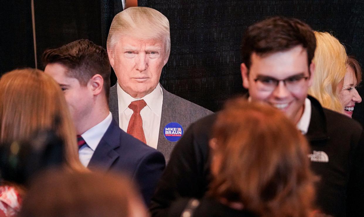 A cut-out of former President Donald Trump sits behind a crowd of Mike Braun supporters on Tuesday, May 7, 2024, during a watch party at Moontown Brewery in Whitestown.