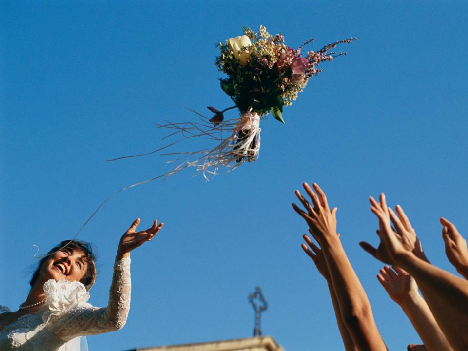 Bride throwing bouquet.