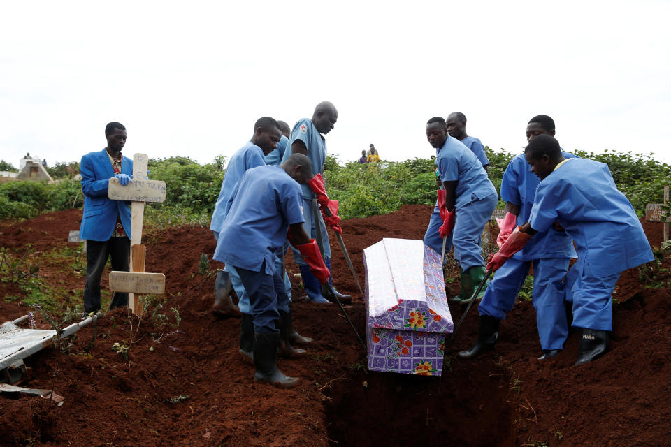 Congolese Red Cross workers carry the coffin of a Congolese woman, Kahambu Tulirwaho, who died of Ebola, during a burial service at a cemetery in Butembo, the Democratic Republic of Congo, March 28, 2019. (Photo: Baz Ratner/Reuters)