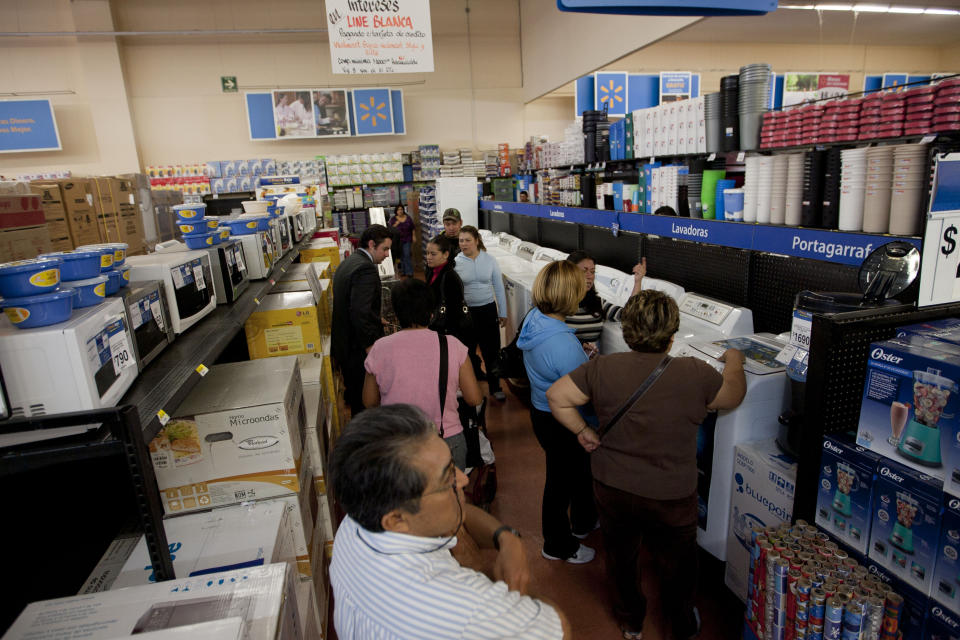 In this Nov. 18, 2011 photo, people shop at a Wal-Mart Superstore in Mexico City. Wal-Mart Stores Inc. hushed up a vast bribery campaign that top executives of its Mexican subsidiary carried out to build stores across Mexico, according to a published report by the New York Times. (AP Photo)