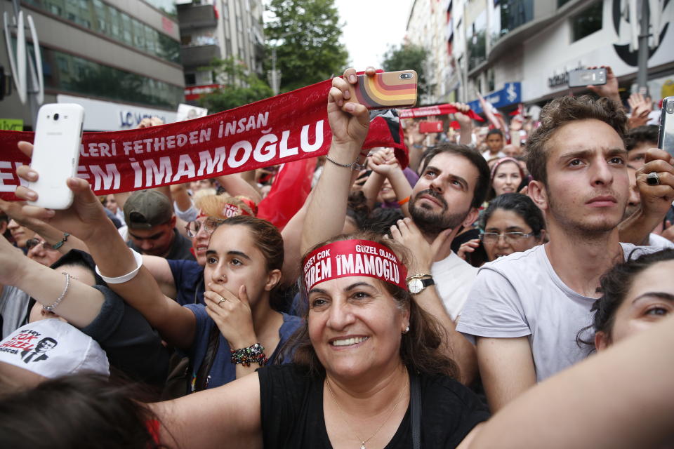 In this Wednesday, June 19, 2019 photo, supporters of Ekrem Imamoglu, candidate of the secular opposition Republican People's Party, or CHP, cheer as he speaks at a rally in Istanbul, ahead of the June 23 re-run of Istanbul elections. Millions of voters in Istanbul go back to the polls for a controversial mayoral election re-run Sunday, as President Recep Tayyip Erdogan's party tries to wrest back control of Turkey's largest city. (AP Photo/Lefteris Pitarakis)