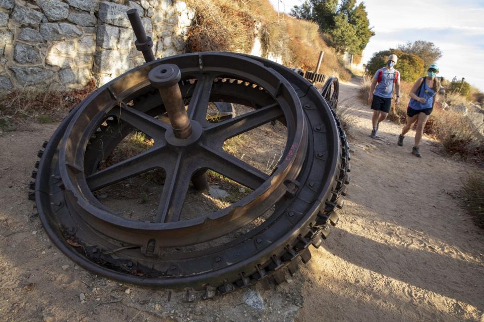 Hikers pass remnants of the old electric railway on the Sam Merrill Trail atop Echo Mountain.