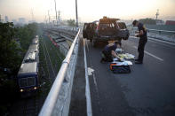 <p>Philippine National Police Scene of the Crime Operations officers inspect 10 kilograms of methamphetamine, known as Shabu, worth around 50 million pesos, found in an abandoned vehicle on a bridge in metro Manila, Philippines on June 2, 2016. (REUTERS/Romeo Ranoco) </p>