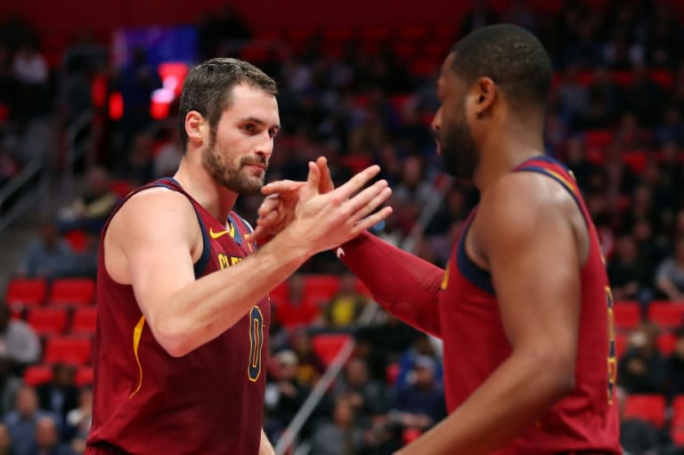 Kevin Love of the Cleveland Cavaliers celebrates a first half basket with Dwyane Wade against the Detroit Pistons