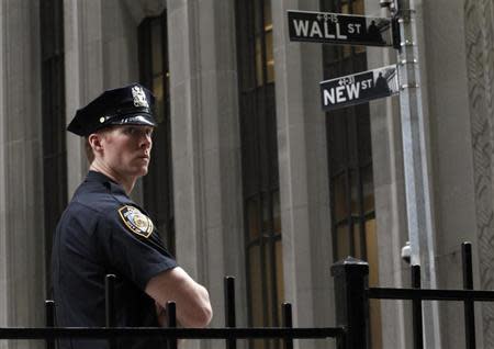 A New York City police officer stands outside the New York Stock Exchange, on Wall Street, May 14, 2012. REUTERS/Brendan McDermid