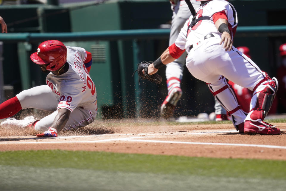 Philadelphia Phillies' Andrew McCutchen steals home as Washington Nationals catcher Yan Gomes can't make the tag in time during the first inning of a baseball game at Nationals Park, Thursday, May 13, 2021, in Washington. (AP Photo/Alex Brandon)