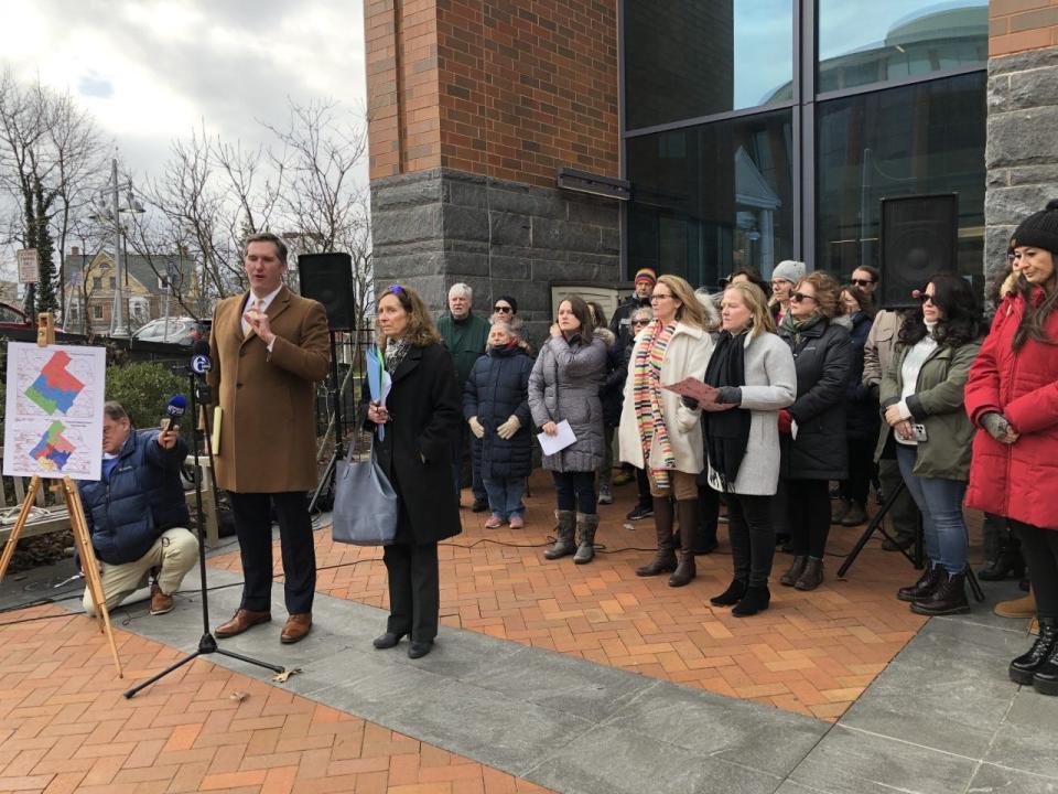 Attorney Brendan Flynn speaks as attorney Theresa Golding (next to Flynn) and members of CBSD Fair Votes listen during a press conference Friday at the Bucks County Justice Center in Doylestown.  The group filed a petition for a new plan to realign the school district's nine regions for fairer voting.