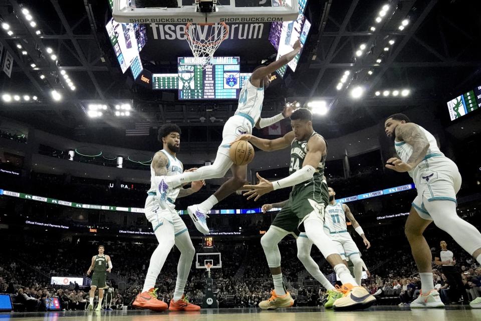 Milwaukee Bucks' Giannis Antetokounmpo is fouled by Charlotte Hornets' Brandon Miller during the first half of an NBA basketball game Friday, Feb. 9, 2024, in Milwaukee. (AP Photo/Morry Gash)
