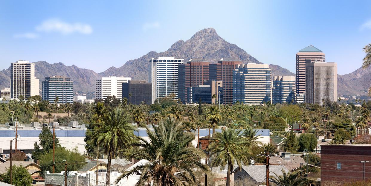 Downtown Scottsdale and suburbs of Phoenix, Arizona, with the White Tank Mountain Range in the background in morning light.