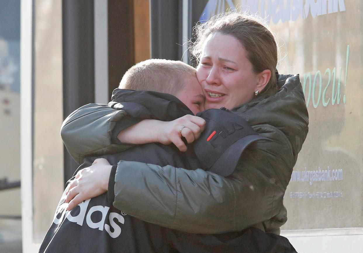 A steel plant employee evacuated from Mariupol hugs her son in Bezimenne, Ukraine, on Sunday. 