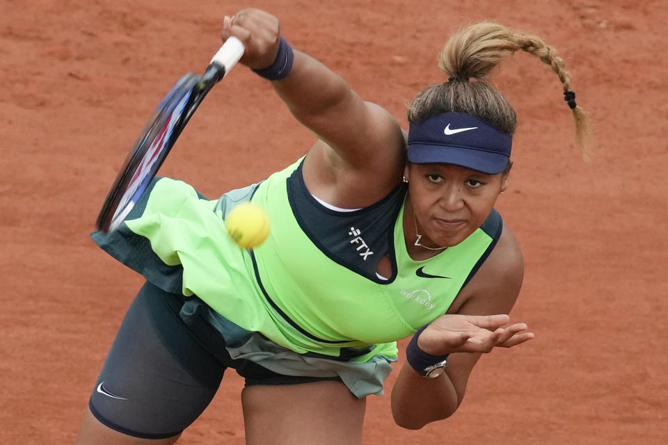 Japan's Naomi Osaka serves against Amanda Anisimova of the U.S. during their first round match at the French Open tennis tournament in Roland Garros stadium in Paris, France, Monday, May 23, 2022. (AP Photo/Christophe Ena)